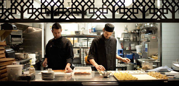 Chefs putting some sweet sanafir into a dish