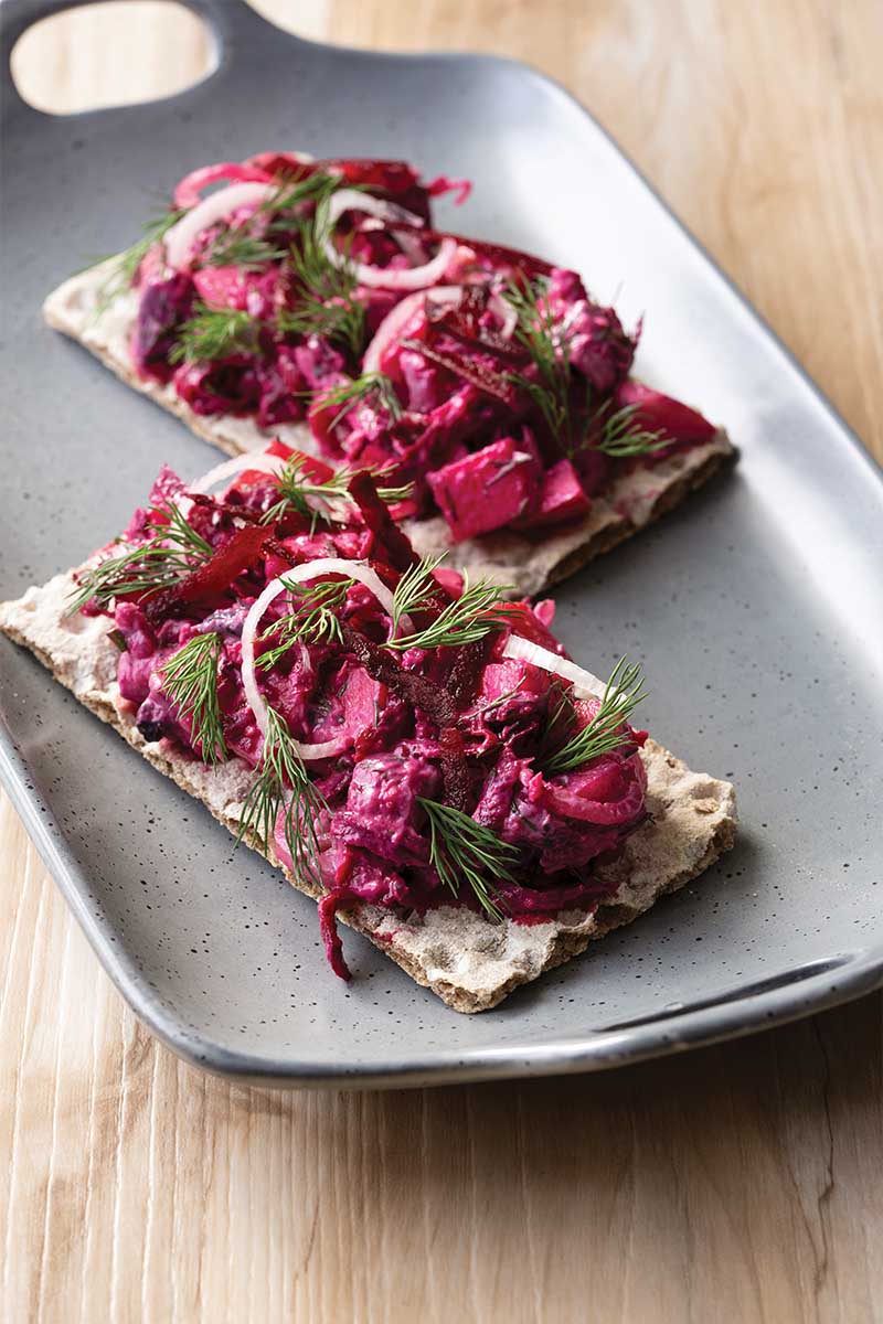 Herring beet apple salad on rye crisps Scandinavian